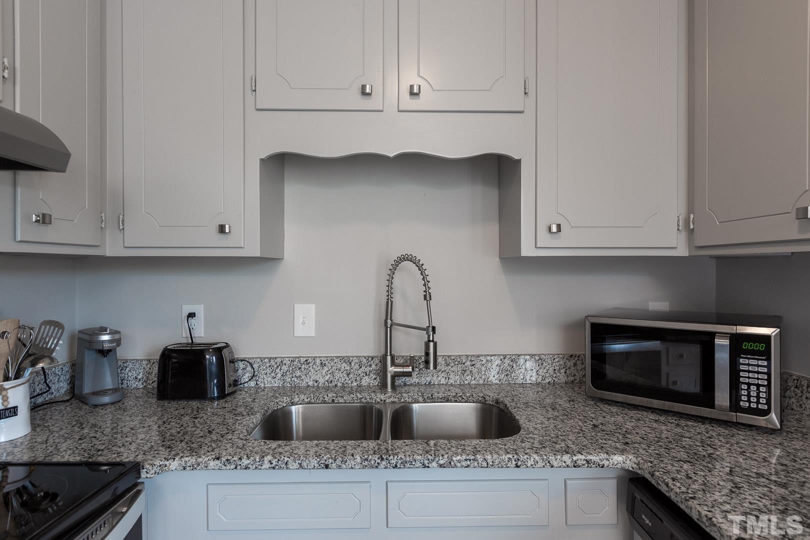 1558 Langdon Road Angier, NC 27501 - Photo 10 of 25 a kitchen with granite countertop white cabinets and a sink