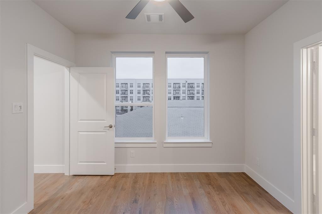1144 Lavender Ridge Dallas, TX 75204 - Photo 12 of 18 an empty room with wooden floor and windows