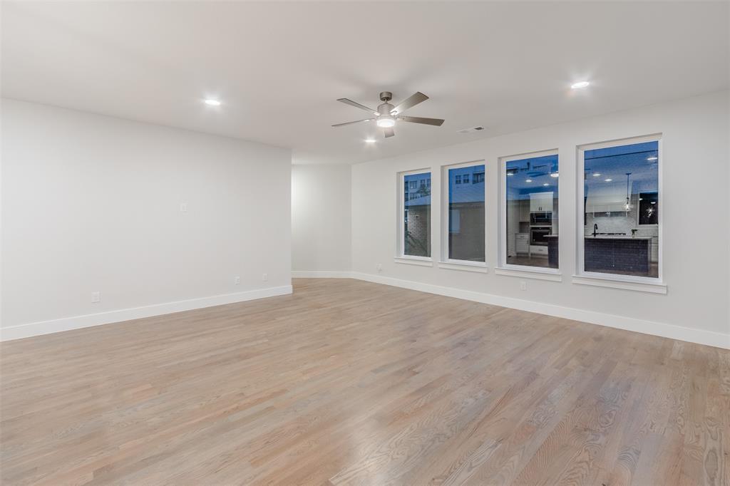 1144 Lavender Ridge Dallas, TX 75204 - Photo 5 of 18 a view of an empty room with chandelier fan and wooden floor