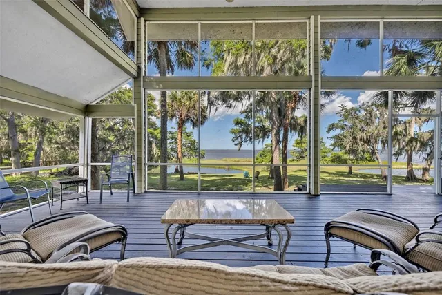 a living room with furniture and a floor to ceiling window