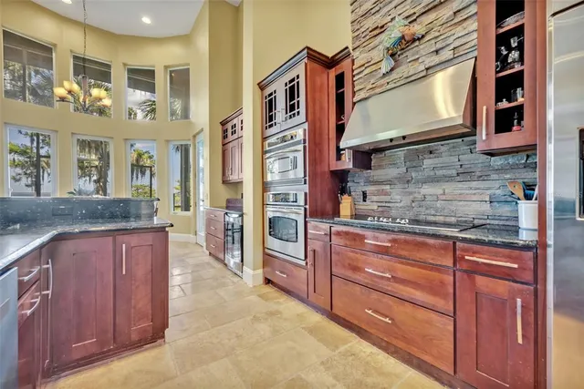 a kitchen with stainless steel appliances granite countertop a stove and cabinets