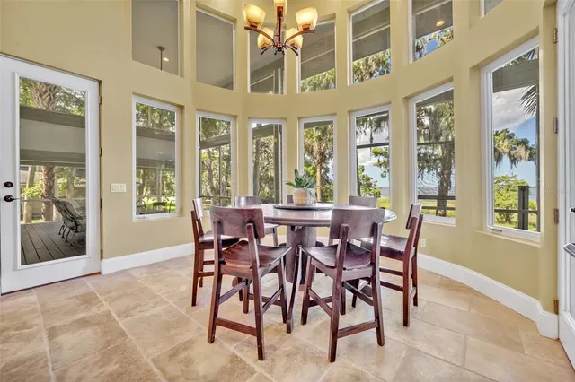 a view of a dining room with furniture and windows