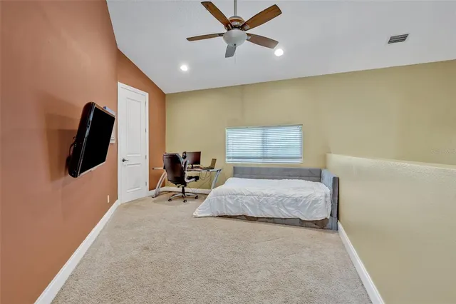 a bedroom with a bed a desk and chair