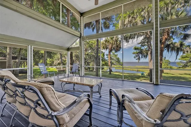 a view of a dining room with furniture a chandelier and wooden floor