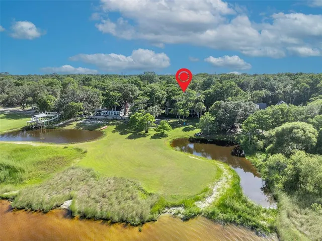 a view of a lake with a house in the background