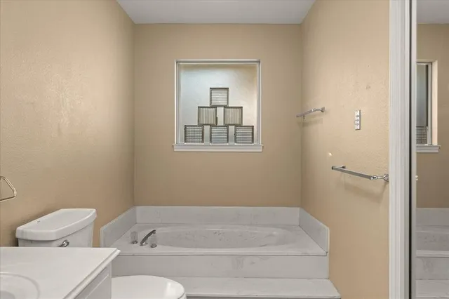 a bathroom with a bathtub and toilet