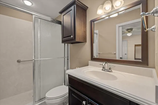 a bathroom with a sink toilet double vanity and shower
