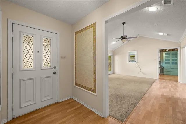 a view of an empty room with window and closet area