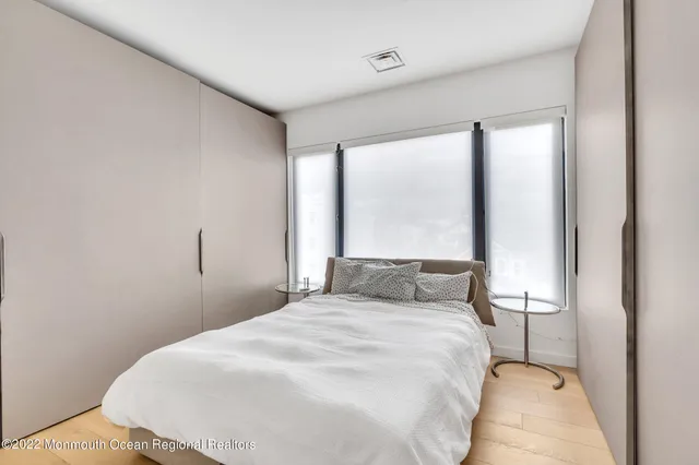 a bathroom with a double vanity sink a toilet and a mirror