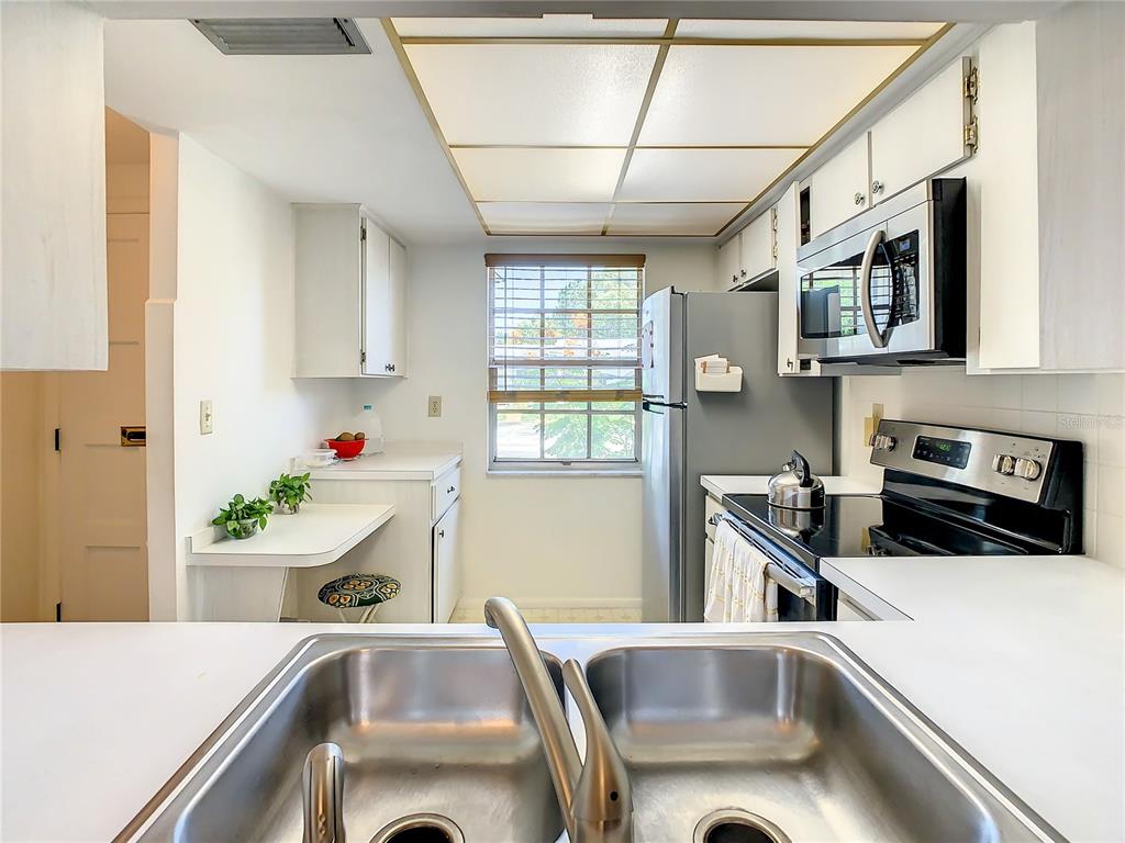 4230 Redcliff Place, Unit 4230 New Port Richey, FL 34652 - Photo 5 of 42 a kitchen that has a sink and a stove top oven