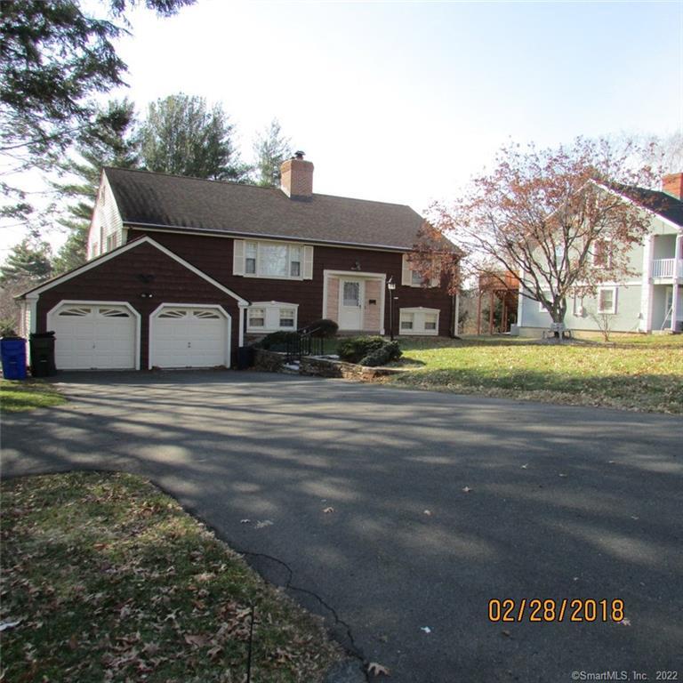 1011 Ridge Road Wethersfield, CT 06109 - Photo 1 of 1 a front view of a house with a yard