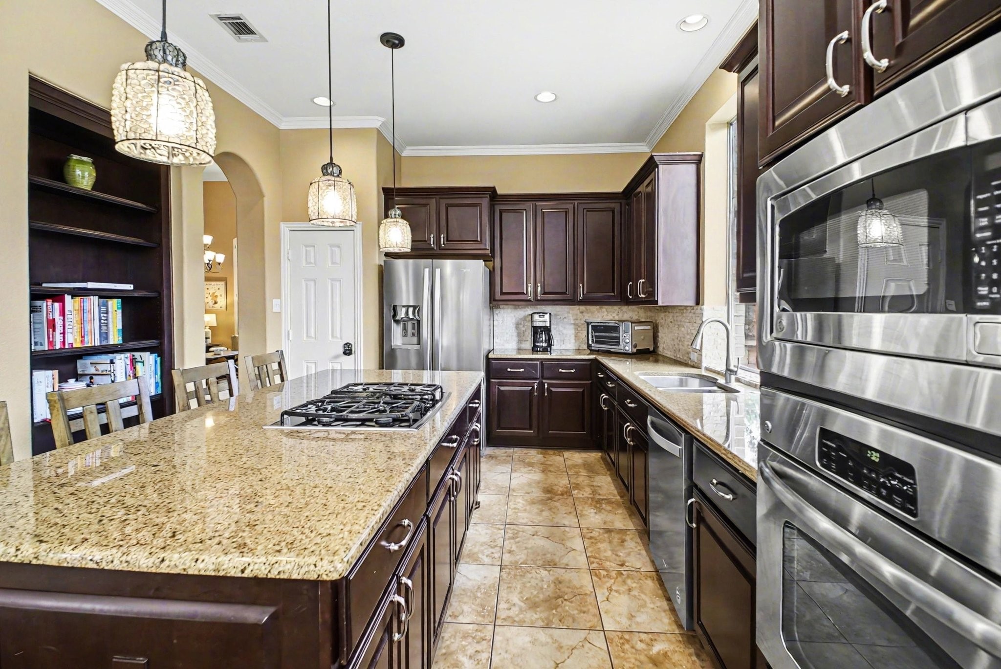 8210 Thunder Ridge Way Missouri City, TX 77459 - Photo 18 of 42 Experience elegance in the kitchen with a stunning granite bar and rich mahogany cabinets.