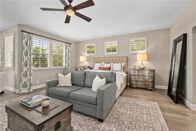 a bedroom with a bed and a chandelier