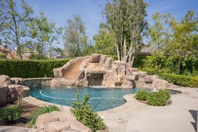 a view of a patio with a table and chairs and potted plants
