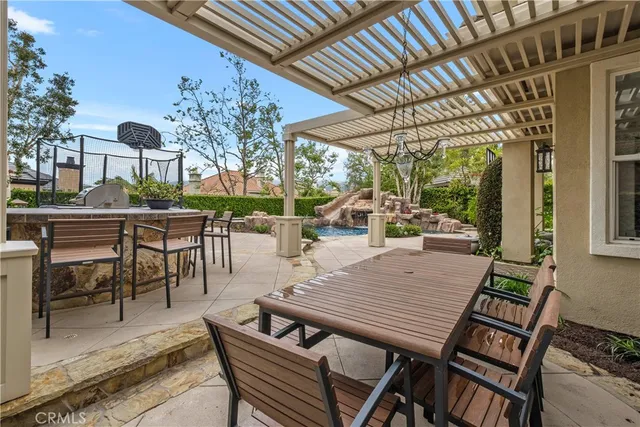 a view of a swimming pool with a yard and a large tree