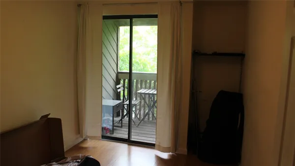 a view of an entryway with wooden floor