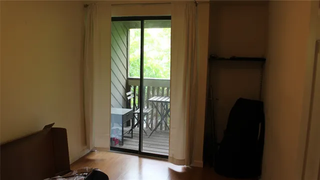 a view of an entryway with wooden floor