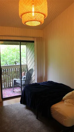 a bed sitting in a bedroom next to a window