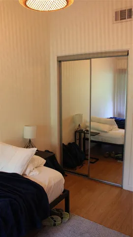 a bedroom with a bed and a window