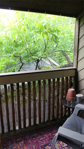 a wooden bench sitting in front of a building