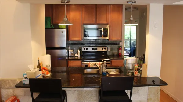 a kitchen with a refrigerator and a stove