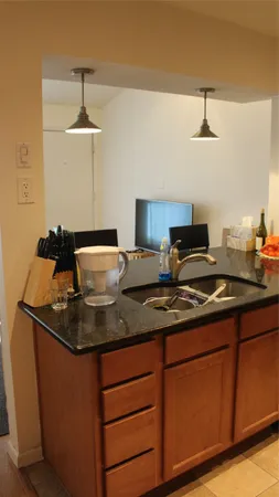a kitchen with stainless steel appliances granite countertop a sink stove and cabinets