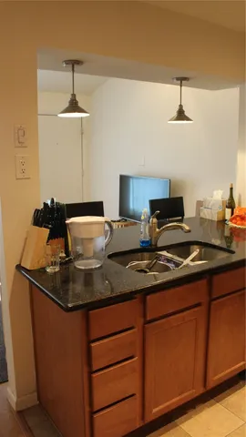a kitchen with stainless steel appliances granite countertop a sink stove and cabinets