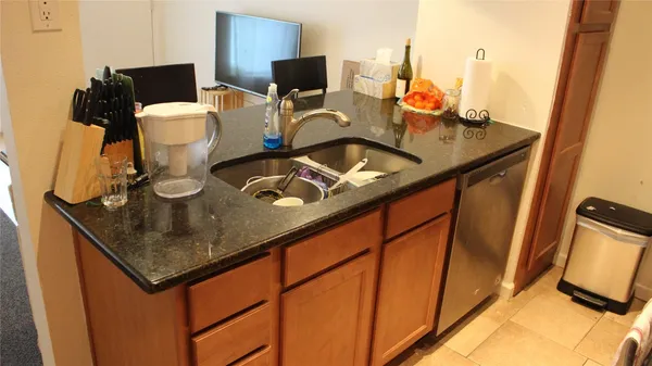 a kitchen with a sink and cabinets