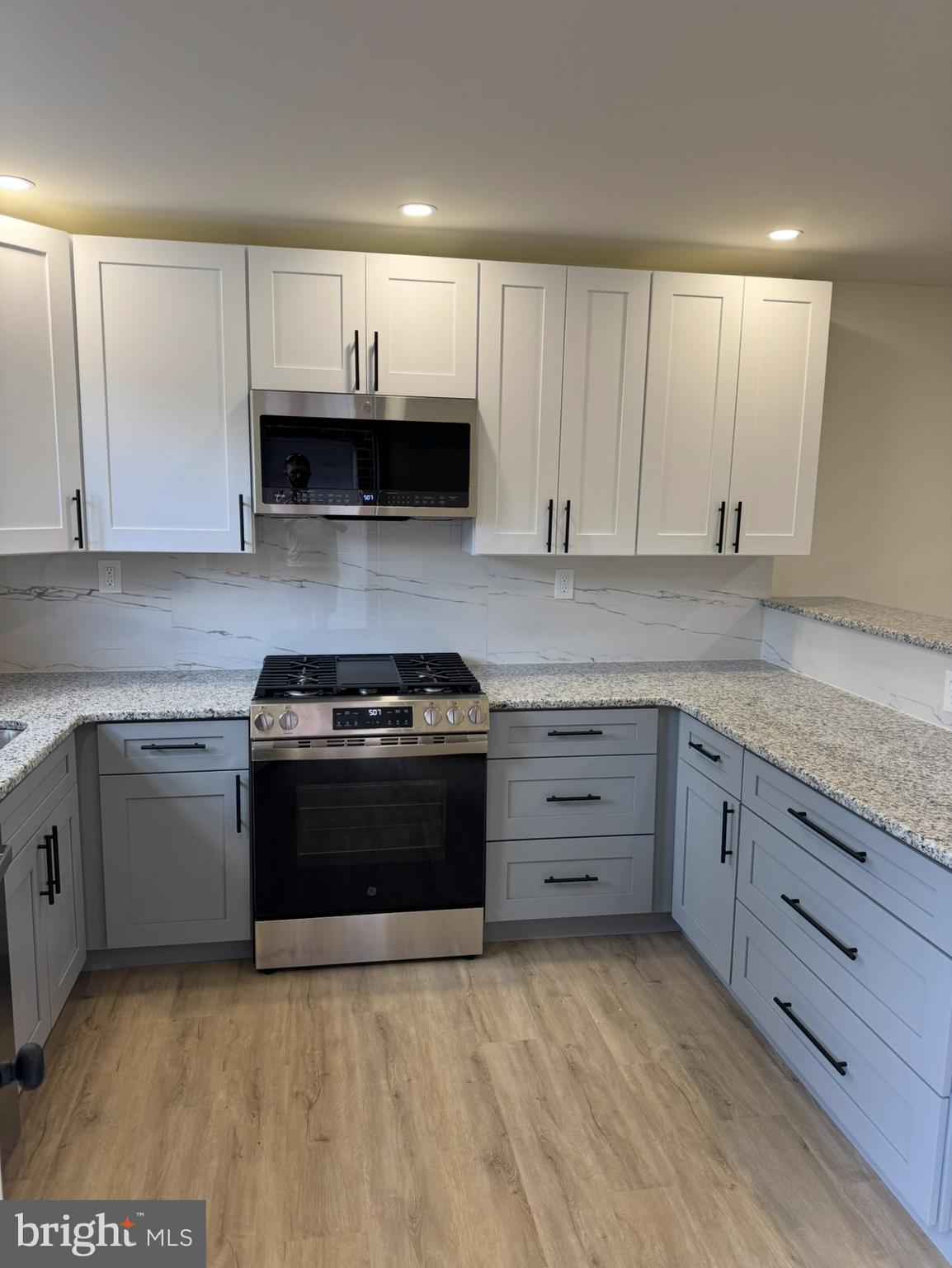 7816 Temple Road Philadelphia, PA 19150 - Photo 3 of 24 a kitchen with granite countertop a stove and a sink