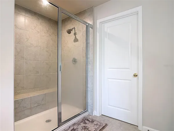 a bathroom with a glass shower door