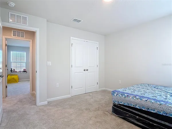 a bedroom with a bed and a table in it
