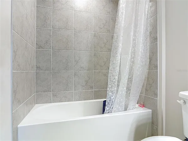 a bathroom with a bathtub and toilet