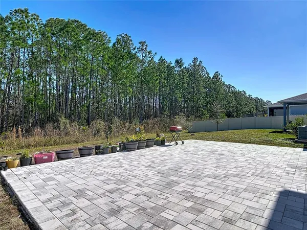 a backyard of a house with lots of green space and trees