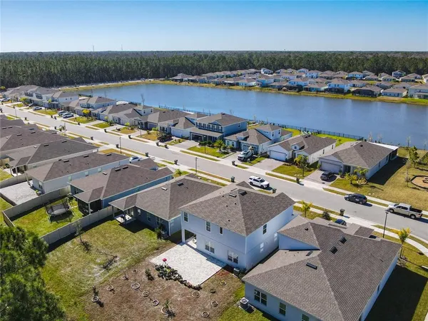 an aerial view of a house with a lake view
