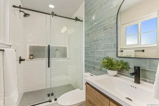 a bathroom with a sink toilet and shower