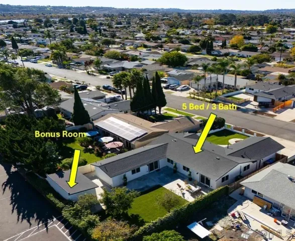 an aerial view of a house with a swimming pool