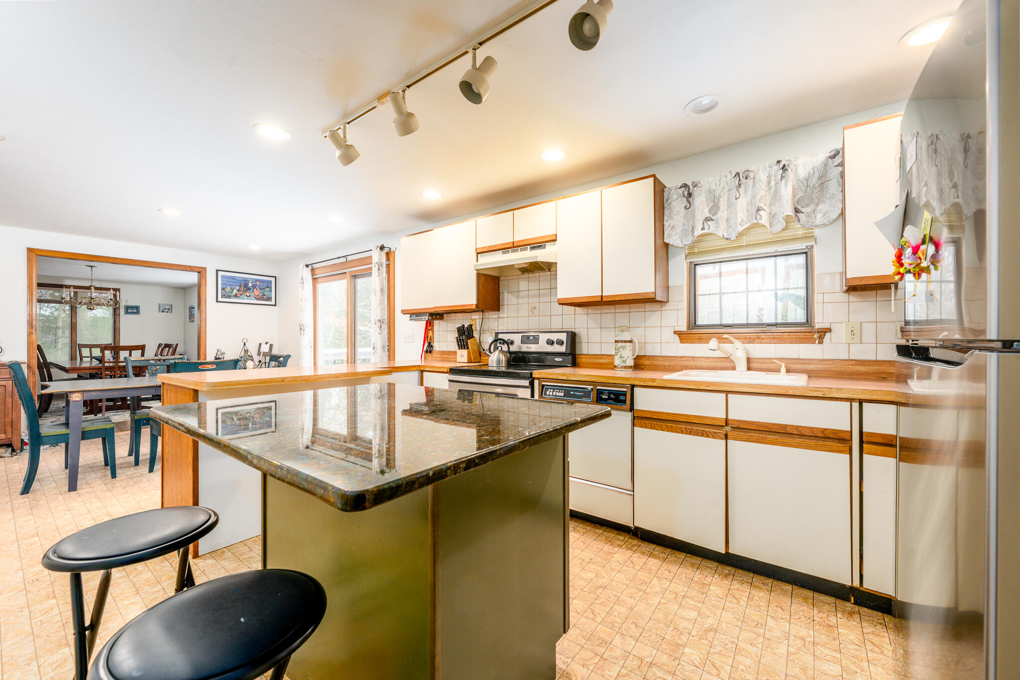 192 Sandy Valley Road Marstons Mills, MA 02648 - Photo 21 of 36 a kitchen with a table chairs stove and cabinets