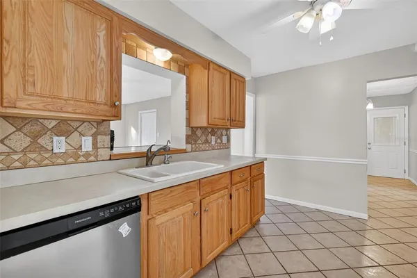 a kitchen with a sink cabinets and window