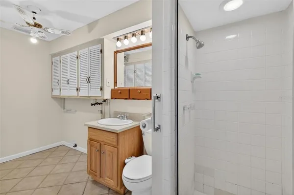 a bathroom with a toilet a sink and a mirror