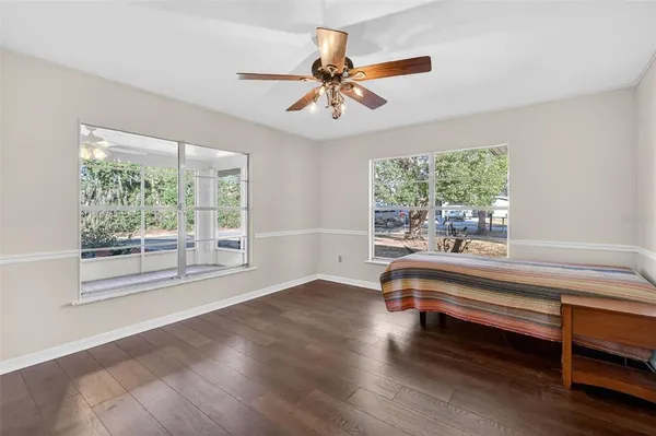 a living room with hardwood floor and a window