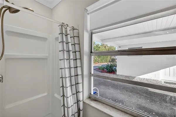 a bathroom with a shower and a window