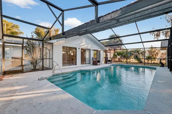 a view of a swimming pool with a patio