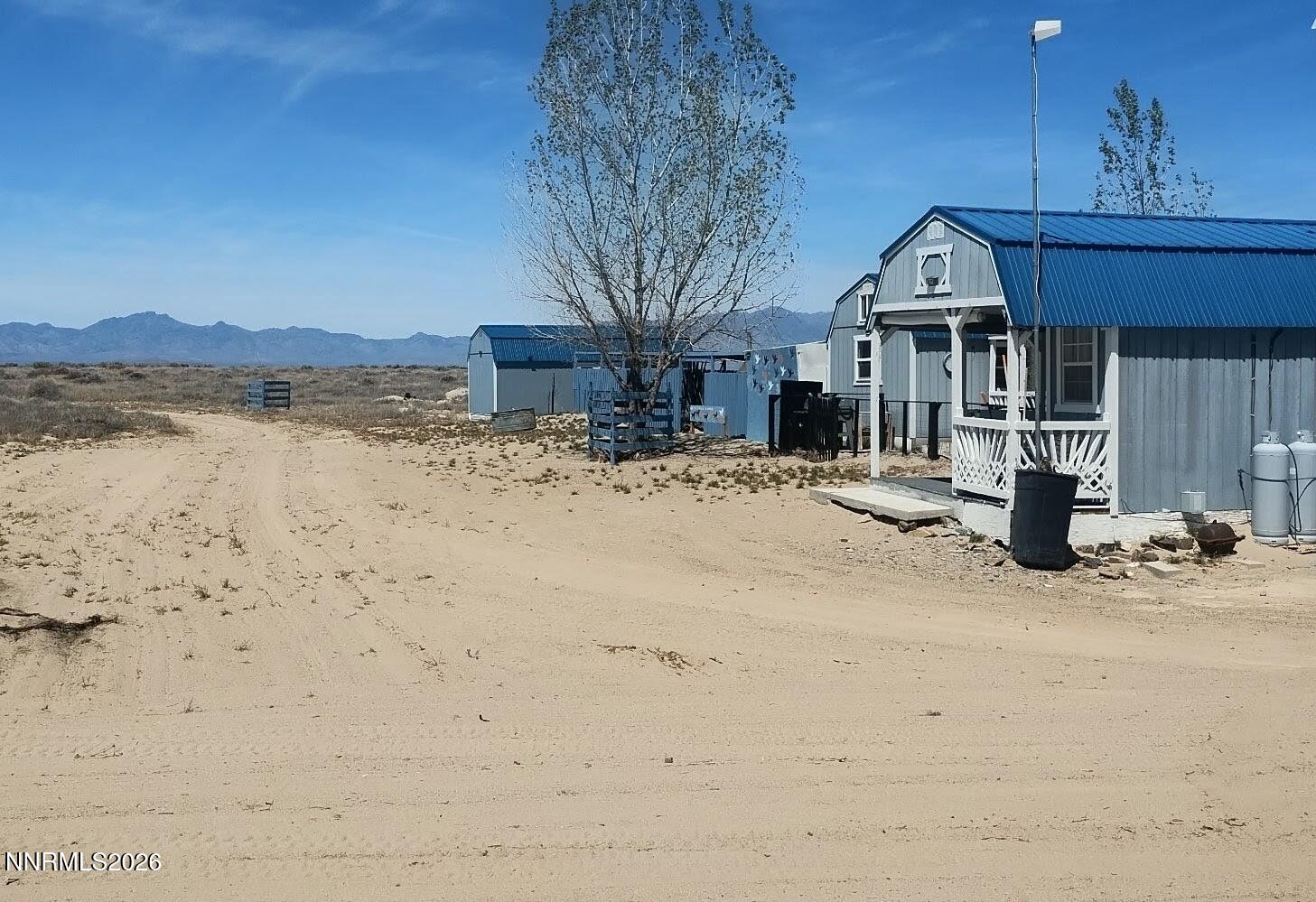 0 Blue Mountain Rd Street Winnemucca, NV 89445 - Photo 5 of 28 a front view of a house with a yard