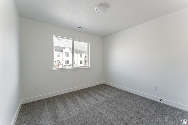 4774 Alder Drive Mapleton, UT 84664 - Photo 18 of 27 Unfurnished room with baseboards and dark carpet