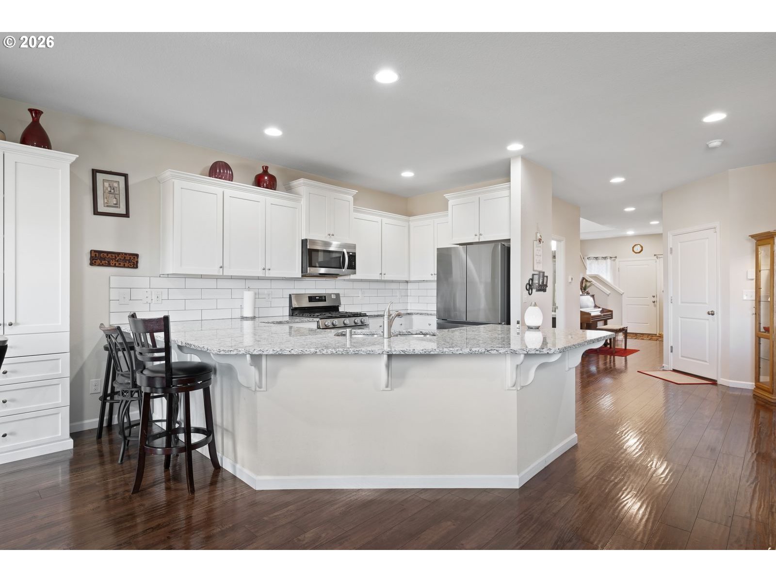 3676 North 10th Street Ridgefield, WA 98642 - Photo 11 of 37 a view of kitchen with stainless steel appliances refrigerator stove microwave and dining table