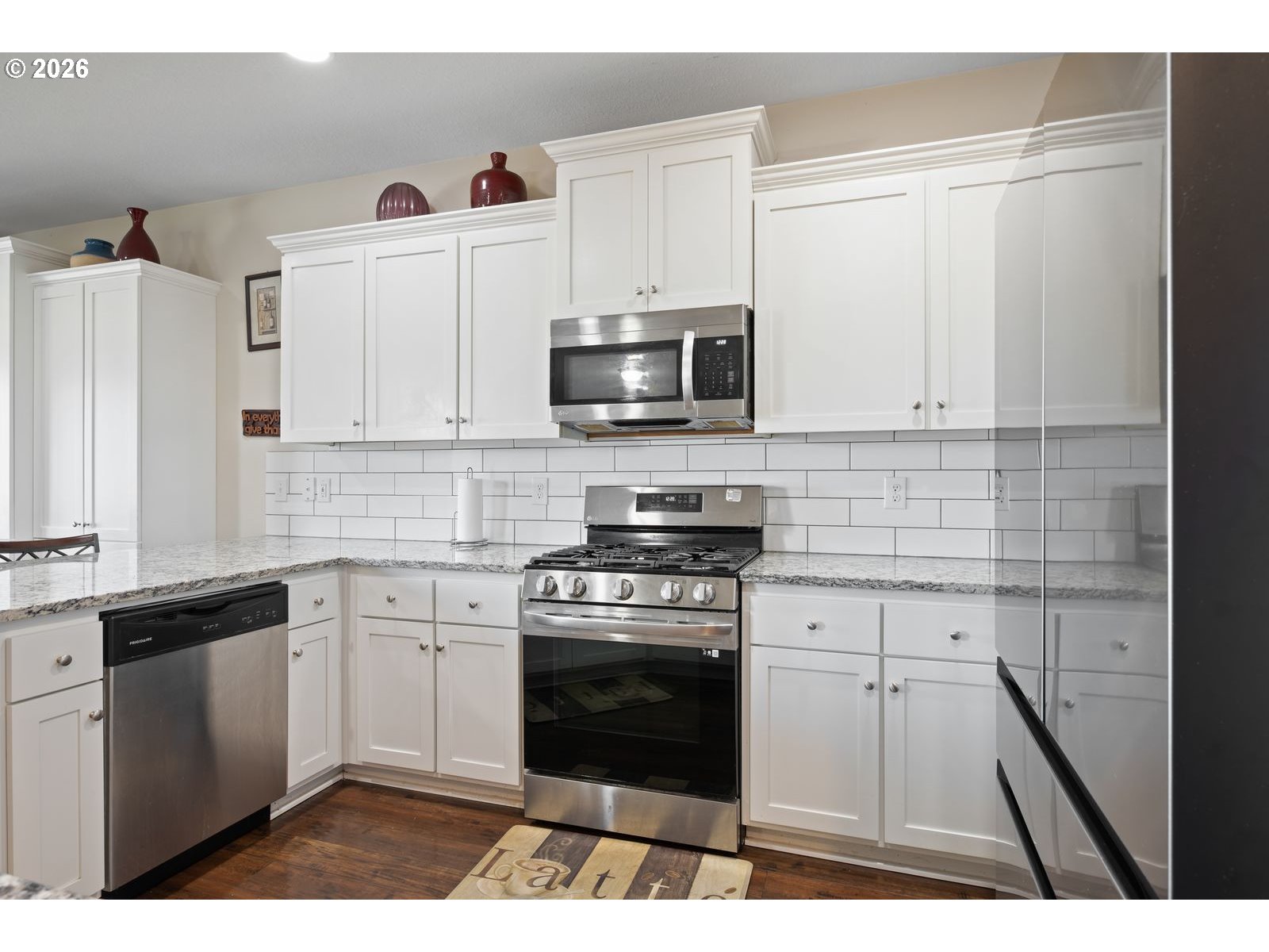 3676 North 10th Street Ridgefield, WA 98642 - Photo 13 of 37 a kitchen with a stove and a microwave