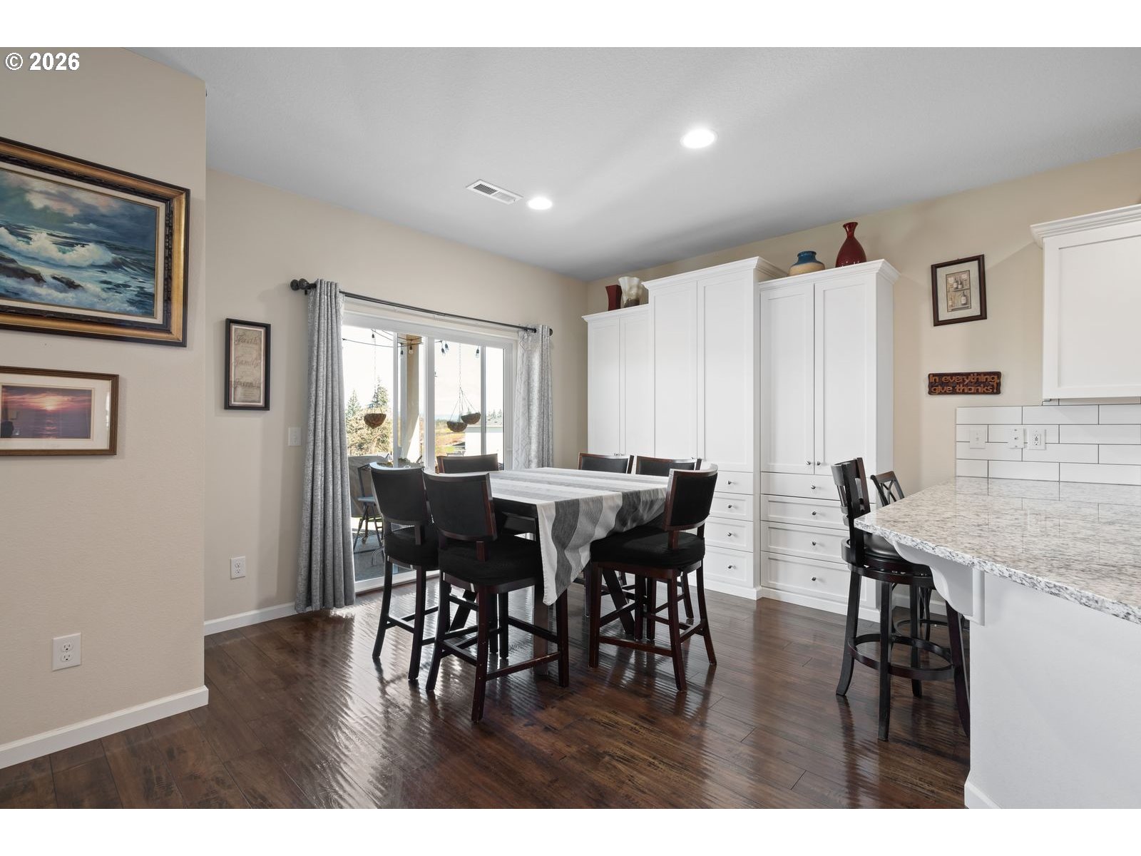 3676 North 10th Street Ridgefield, WA 98642 - Photo 18 of 37 a view of a dining room with furniture and wooden floor