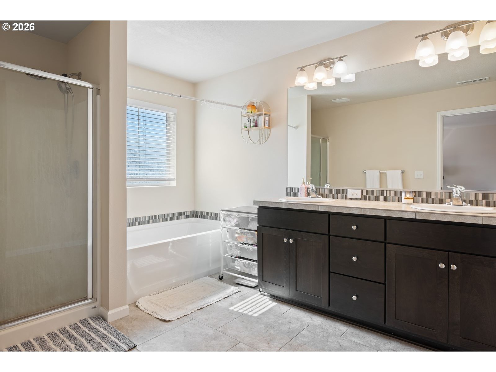 3676 North 10th Street Ridgefield, WA 98642 - Photo 21 of 37 a bathroom with a vanity granite tub shower and a mirror