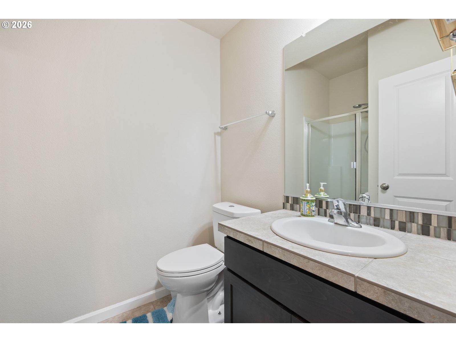 3676 North 10th Street Ridgefield, WA 98642 - Photo 34 of 37 a bathroom with a granite countertop sink a toilet and a mirror