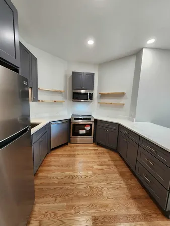 a stove top oven sitting inside of a kitchen